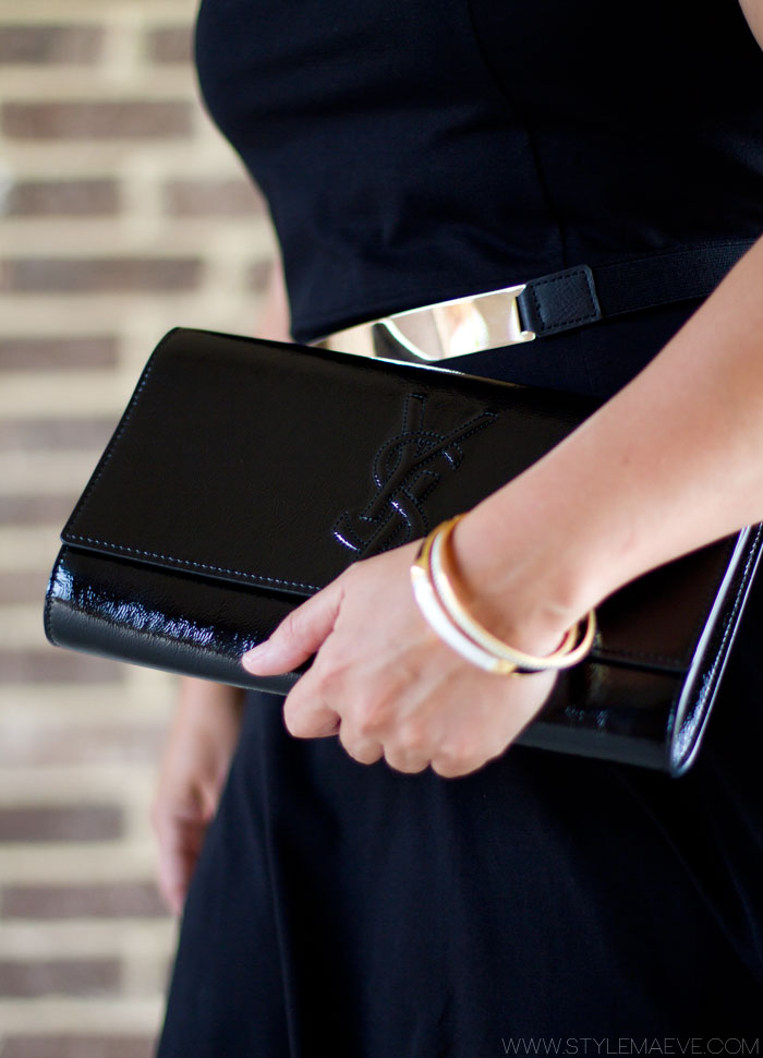 black dress with ysl black patent clutch and gold metal belt
