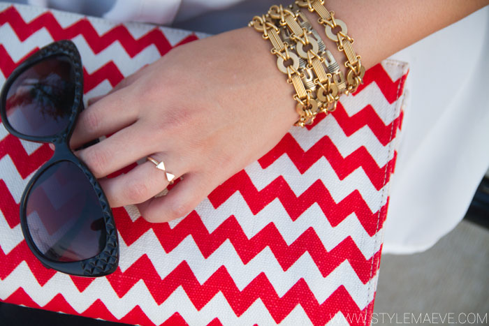 Chevron Clutch by Kate Spade with cat eye sunglasses and gold jewelry